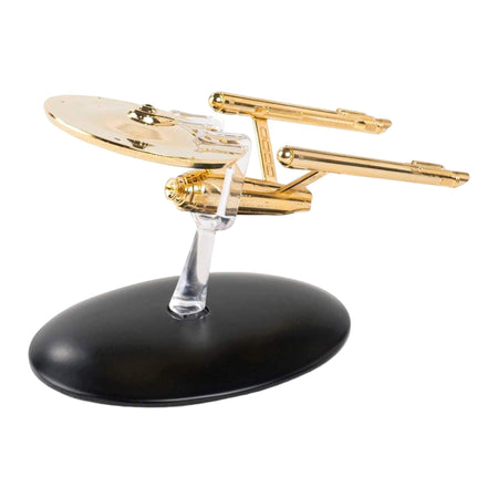 Gold-plated Eaglemoss U.S.S. Enterprise starship replica viewed from the front quarter angle