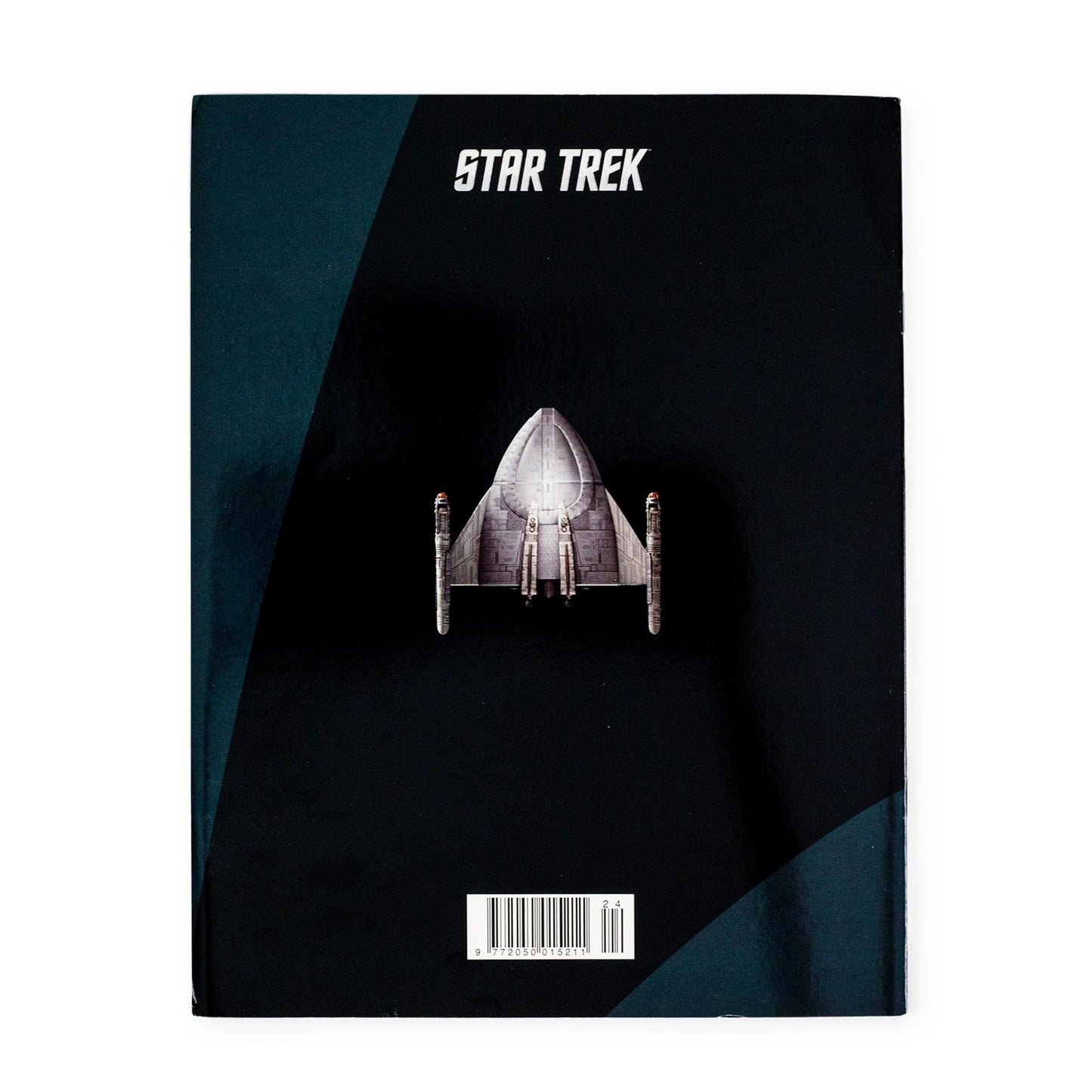 Angled view of the magazine laid flat on a neutral surface showcasing the spine and glossy cover finish