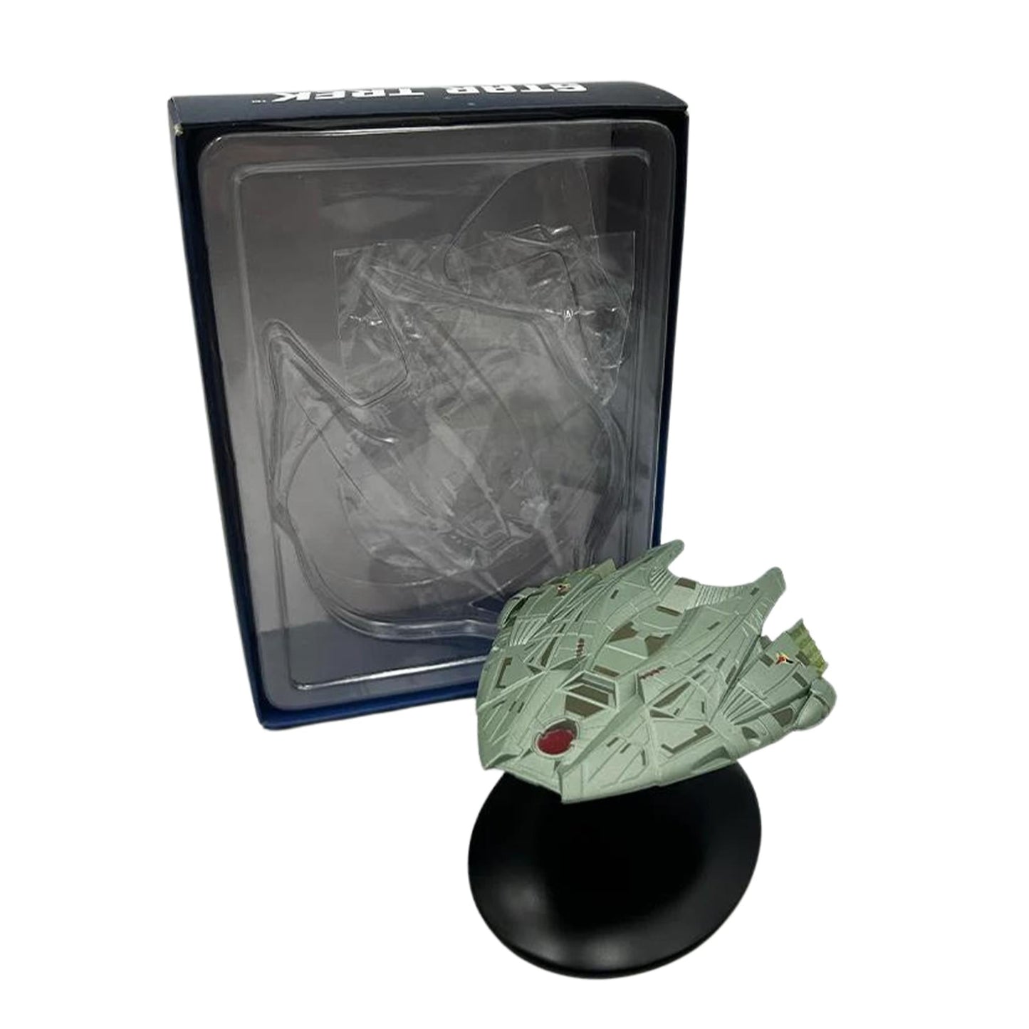 The Klingon Transport replica displayed on a clean desktop surface with atmospheric starlight backdrop lighting