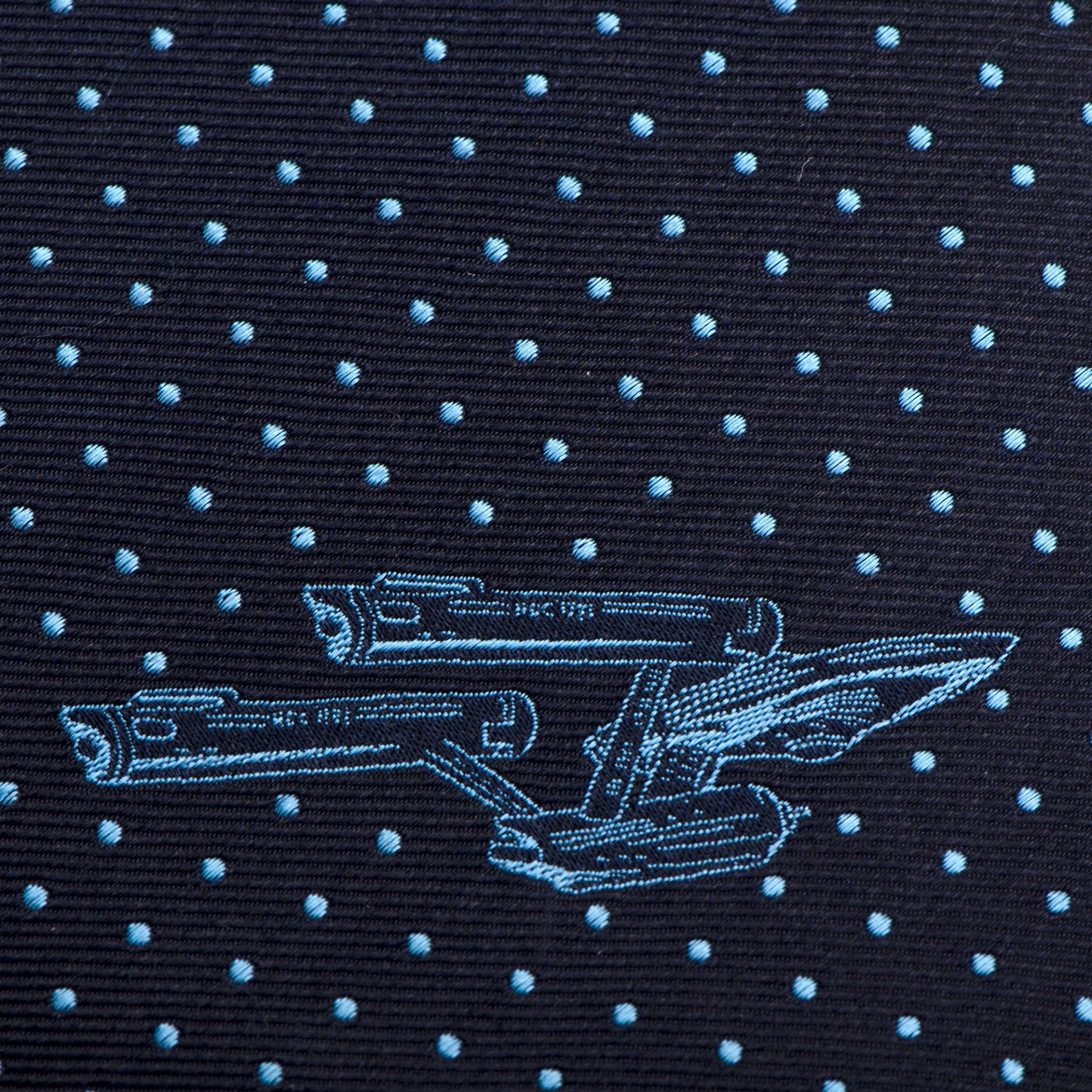 Full length of the slim silk necktie laid flat to show the navy and azure color scheme.