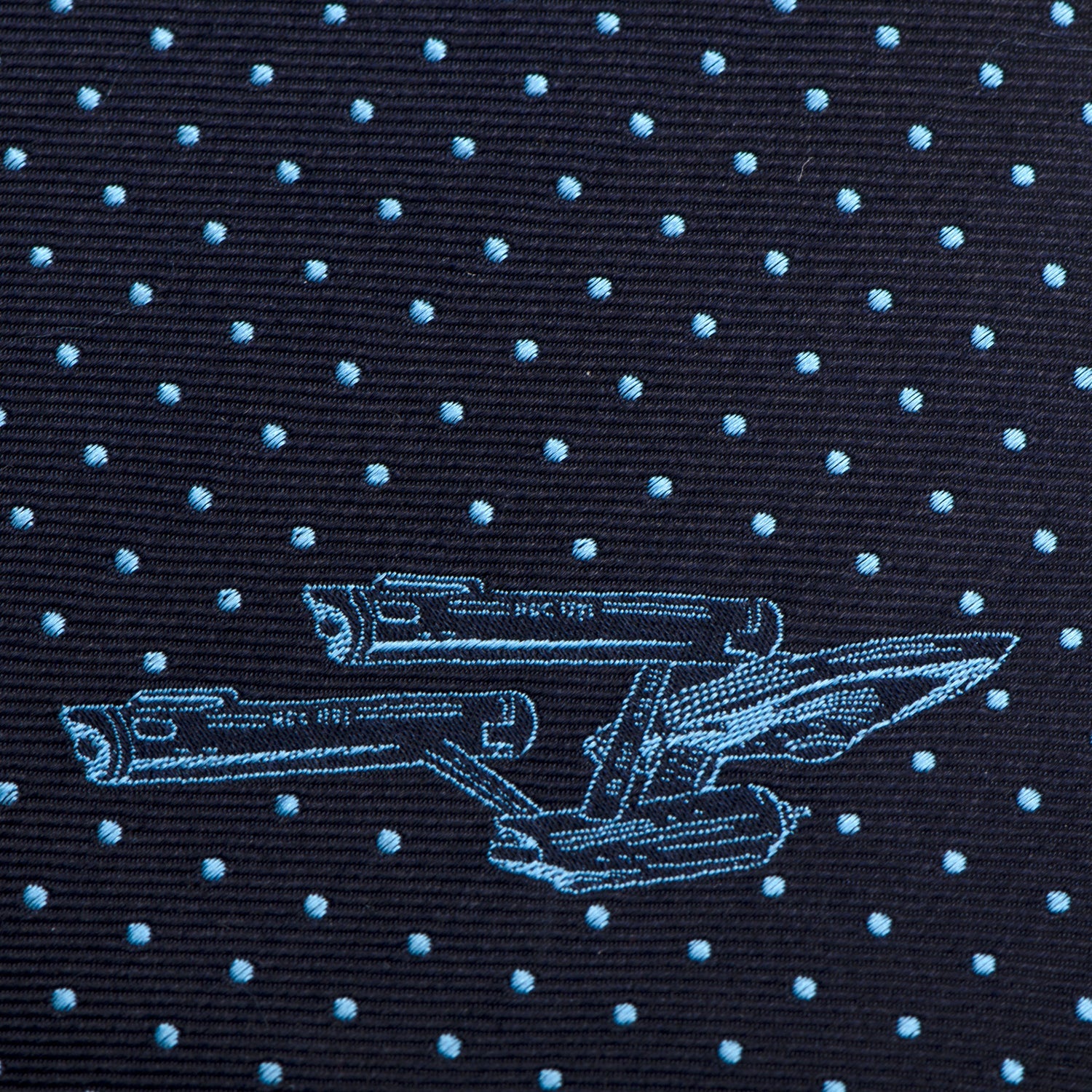Full length of the slim silk necktie laid flat to show the navy and azure color scheme.