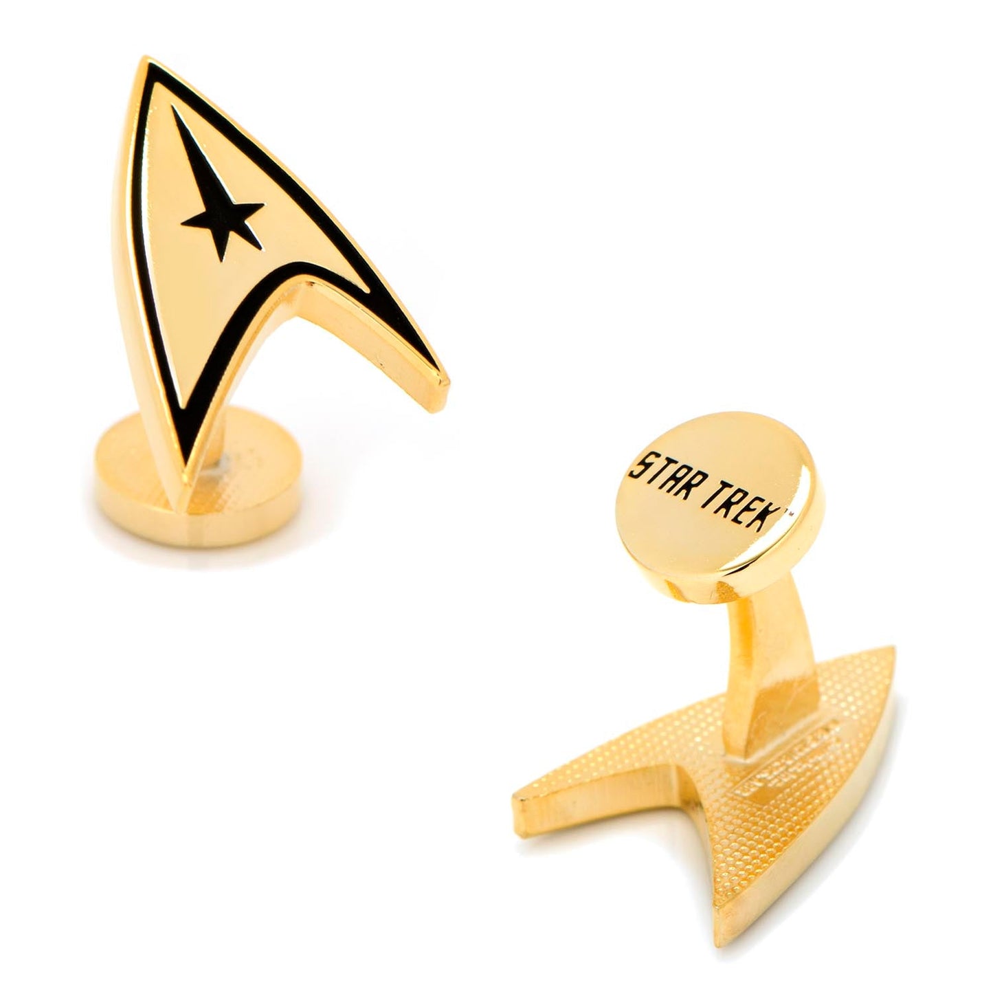 Close-up of gold-plated Star Trek Delta Shield cufflinks against a dark background