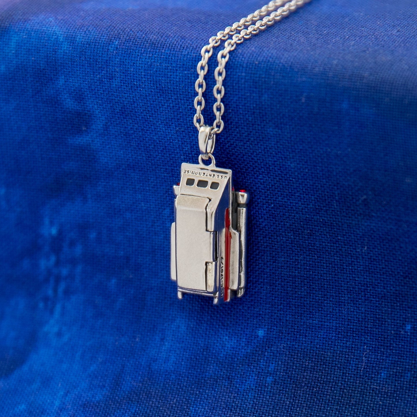 Close up of Galileo shuttlecraft pendant with enamel detail