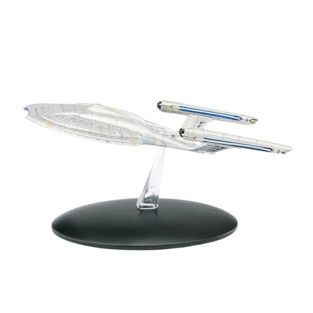 Die-cast model of the USS Enterprise NX-01 starship angled forward against a dark background, showing its saucer section and warp nacelles
