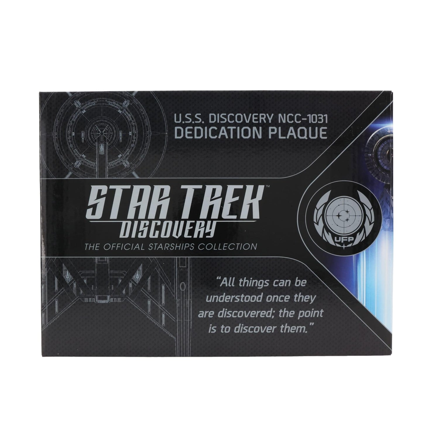 Lifestyle shot of the U.S.S. Discovery plaque mounted on a study wall alongside other Star Trek memorabilia